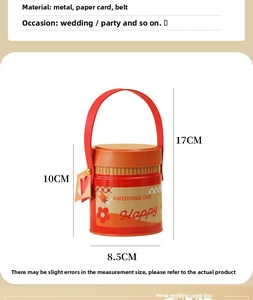 Detail of cylindrical metal candy box with red leather handle and flower pattern
