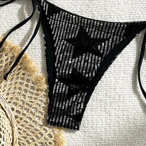 Detailed view of black bikini bottom with silver sequins and side tie strings