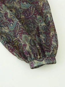 Detail of paisley print chiffon sleeve with metallic threads and elastic cuffs