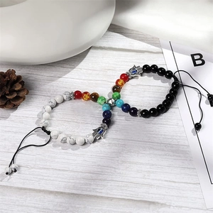 Detail of magnetic couple bracelets with white turquoise beads and Hamsa Hand charm