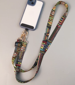 Detail of adjustable crossbody phone strap with colorful ethnic pattern and metal buckle