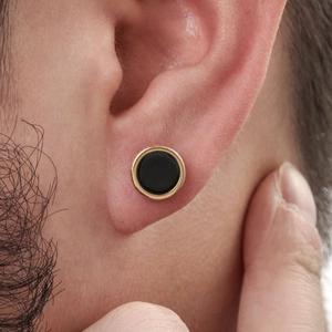 Men's geometric stainless steel round earring with black center and golden edge on ear
