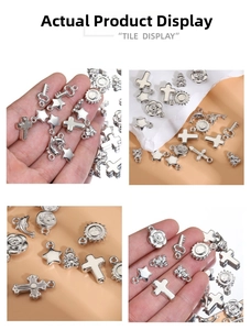 Detailed view of silver Y2K charms including crosses and stars for DIY jewelry