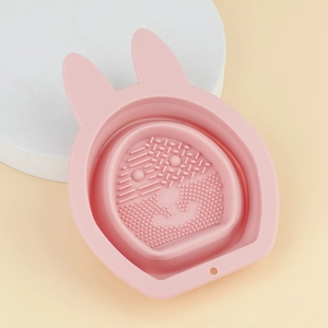Macro shot of pink bunny-shaped silicone makeup brush cleaning bowl with scrubbing texture
