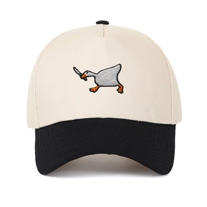 Two-tone baseball cap with cream crown and black brim featuring goose knife embroidery