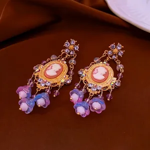 Vintage palace style floral tassel earrings with cameo carving and purple crystals