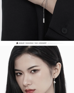 Detail view of minimalist silver chain bracelet and elegant pearl tassel earrings on model