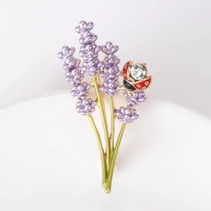 Elegant lavender and red ladybug brooch with rhinestones on a minimalist white base