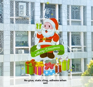 Détail de stickers de Noël statiques avec Père Noël et texte sur vitre humide
