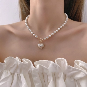 Detail of elegant pearl heart necklace with crystal pendant and gold OT toggle clasp