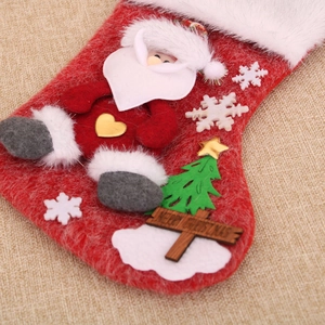 Detail of red felt Christmas stocking with 3D Santa Claus and Merry Christmas sign