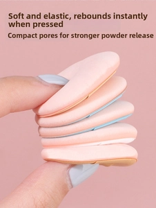 Close-up showing the elasticity and soft texture of mini finger makeup puffs in skin pink