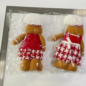 Detail shot of Christmas gingerbread man plush dolls with ruler showing 35cm height
