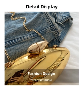 Detail of glossy gold mango-shaped acrylic evening bag with a metal chain strap