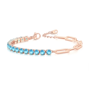 Detail of rose gold paperclip and blue zircon tennis bracelet with lobster clasp