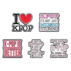Set of 5 K-Pop themed enamel pins with inspirational slogans on white background