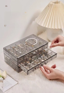 Three-layer clear acrylic jewelry box showing smooth drawer slides and partitioned storage
