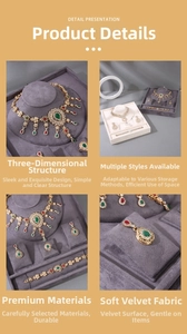 Detail view of retro jewelry display stands with gray velvet for necklaces and rings
