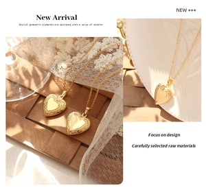 Close-up of vintage heart locket necklace with 18K gold plating and floral engraving