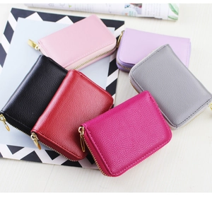 Flat lay of multi-color litchi texture PU leather card holders with gold zippers
