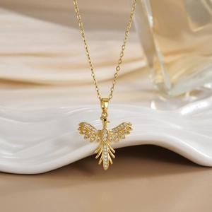 Detailed view of bird pendant with gold plating and cubic zirconia inlay craftsmanship