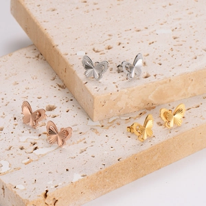 Three-tone stainless steel layered butterfly stud earrings in silver, gold, and rose gold