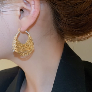 Close-up of 18k gold plated hoop earrings with layered chain tassels and zircon stones
