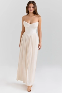Detail of white corset bodice and pleated maxi skirt hem on an elegant dress