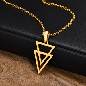 Macro view of gold geometric triangle pendant on a minimalist stainless steel necklace