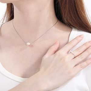 Minimalist silver necklace with irregular pearl pendant and matching multi-pearl slim ring