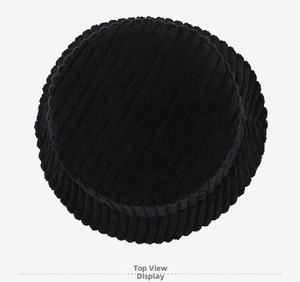 Top view of black corduroy bucket hat showing circular crown and fine ribbed texture