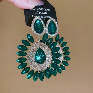 Detailed macro view of green crystal flower earrings with 925 silver luxury finish