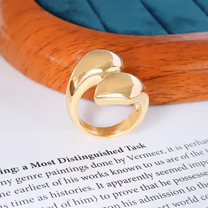 Polished 18K gold-plated stainless steel wrap ring with a fluid liquid metal droplet design