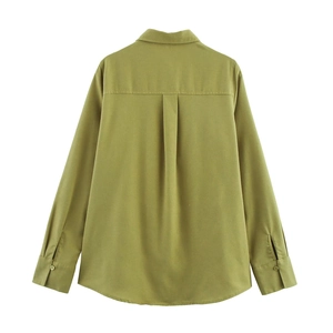 Detail view of linen shirt back featuring central pleat and olive green textured fabric