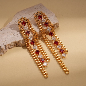 Detail of 18k gold plated long chain tassel earrings with red and white zircons