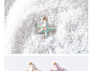 Macro shot of colorful enamel starfish pendants in light blue, white, and purple alloy finish