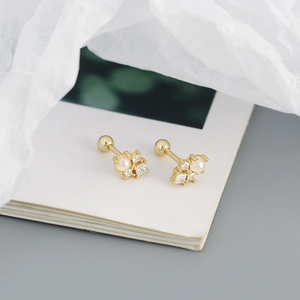 Macro shot of gold pearl stud earrings with square zircons and secure screw back closure