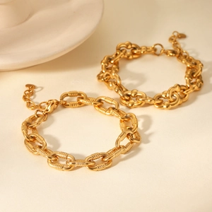 Chunky 18K gold-plated stainless steel bracelet with textured links and a heart charm