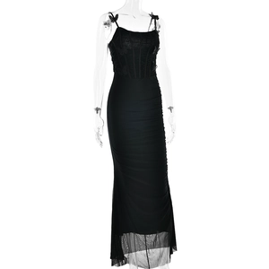 Detail of black bodycon maxi dress featuring waist cinching design and sheer mesh hemline