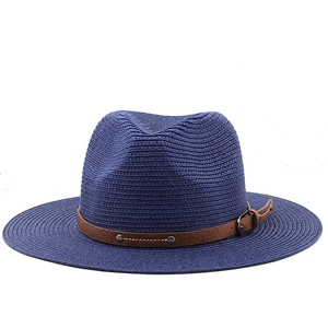 Detailed texture of navy blue straw fedora hat featuring a brown leather studded band