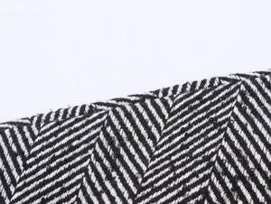 Macro view of black and white herringbone weave fabric with detailed textile texture