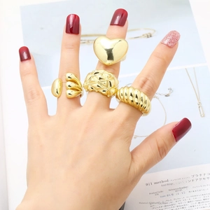 Four-piece gold plated chunky ring set featuring heart and geometric textured designs