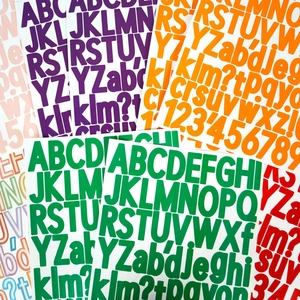 Detailed view of colorful 1.5-inch waterproof alphabet and number stickers in bold font