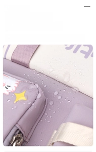Close-up of waterproof purple nylon backpack fabric showing water droplets and texture