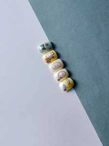 Detail of five cute cartoon cat nail patches with floral and fish patterns in light blue