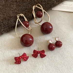 Burgundy pearl earring set with gold geometric dangles and matte red butterfly studs