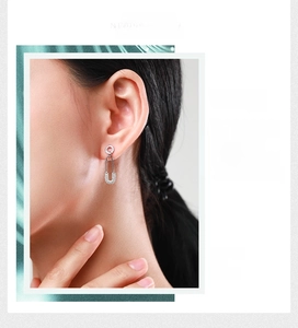Detail of S925 sterling silver safety pin earrings with micro-pave cubic zirconia crystals