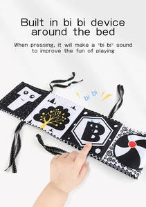 Detail of baby soft book with built-in squeaker showing manual squeeze for sound