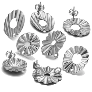 Macro view of silver floral stud earring bases with textured surfaces for DIY jewelry