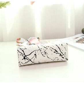 Detail of white marble print tote bag with pink silk scarf handle and gold chain strap